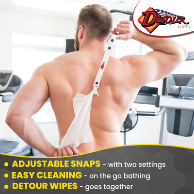 Person using a Detour Wipes scrubber handle with an attached body wipe to clean their back in a gym setting, with Detour branding and text about adjustable snaps and easy cleaning.